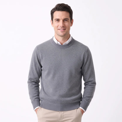 Smiling man wearing the mid grey knitted jumper over a white shirt and beige trousers 35