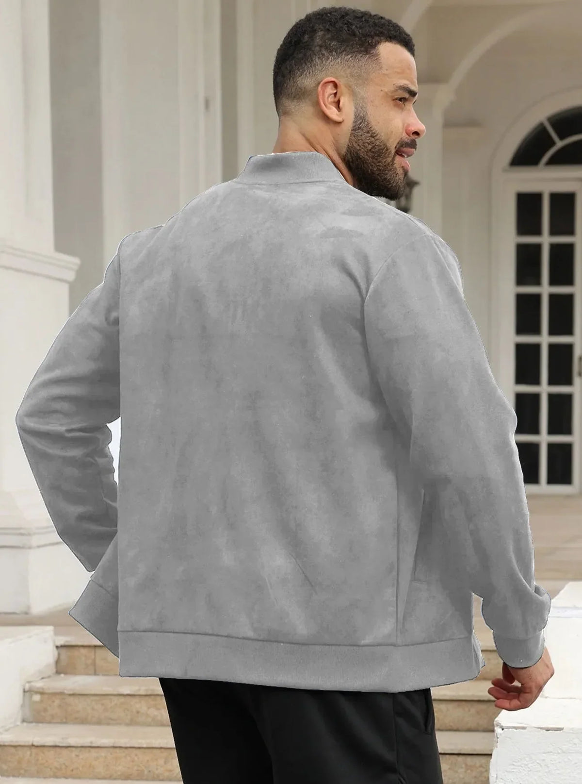 Man wearing the light grey zip-up jacket outdoors, front view, one hand at his collar 35