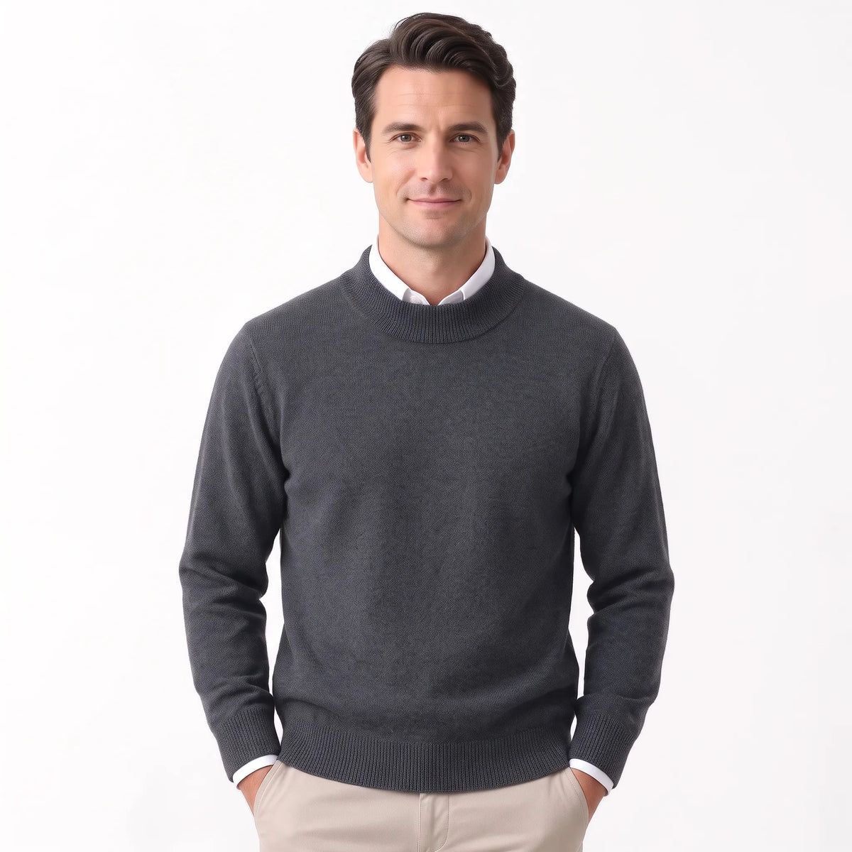 Man wearing the charcoal grey knitted jumper over a white collared shirt with beige trousers 36