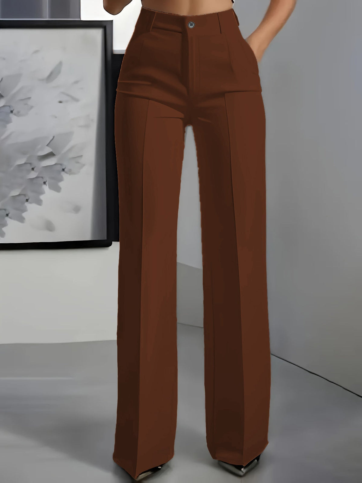 Front view of wide-leg trousers in rust brown with a centre crease, worn with a hand in the pocket 6
