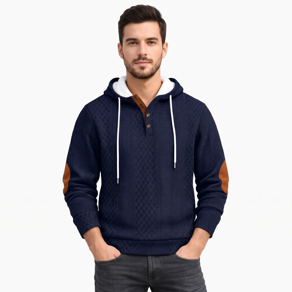 Model in navy textured hoodie with tan elbow patches and white drawcords, hands in pockets, plain background 37
