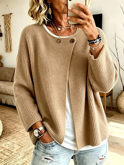 Front view of the camel ribbed cardigan on a model taking a mirror selfie, worn open over a white top 1