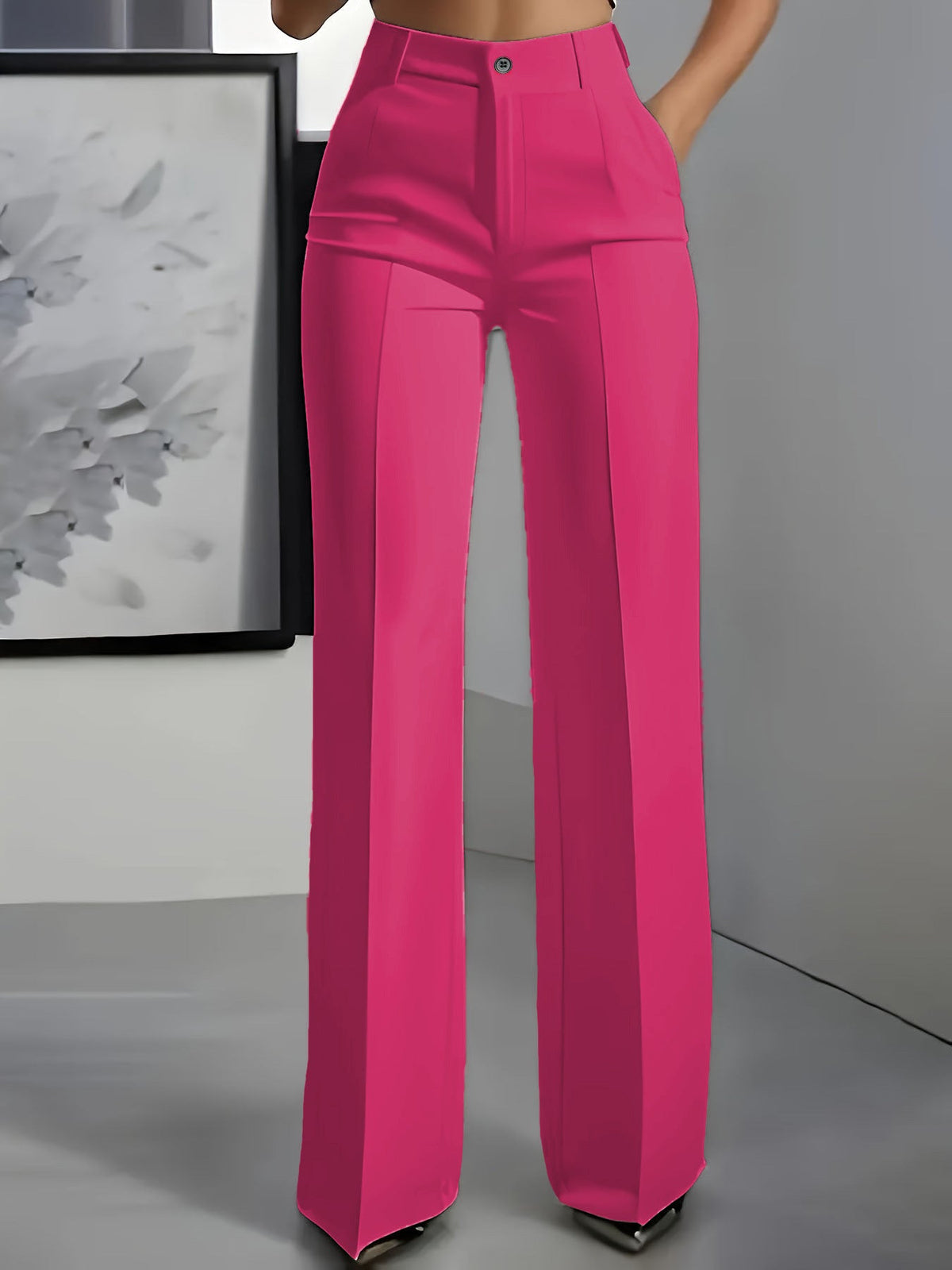 Front view of wide-leg trousers in bright pink with a centre crease, worn with a hand in the pocket 4