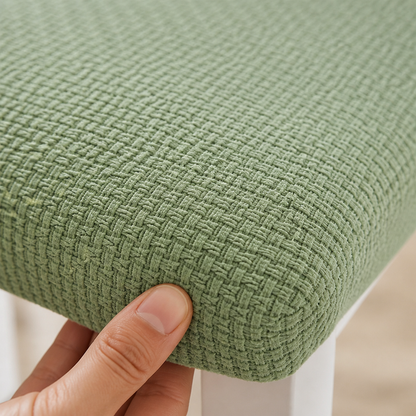 Extreme close-up of the green woven jacquard texture on a seat cover edge, with a fingertip pressing the fabric. 4