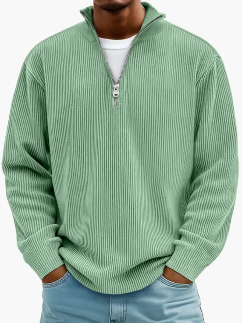 Man wearing the ribbed quarter-zip jumper in soft mint green over a white tee, with light blue jeans. 3