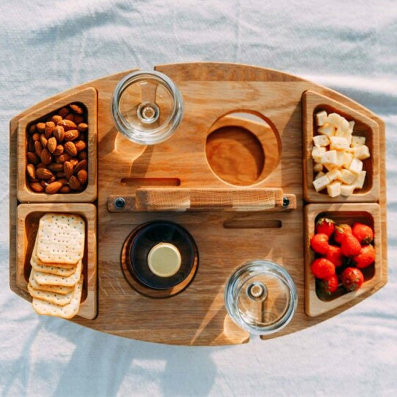 Top-down view of the wooden table with four trays of almonds, crackers, cheese and strawberries 5