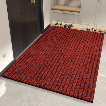 Red version of the striped mat with dark grey grooves between the stripes, shown in a tiled entrance hall. 2