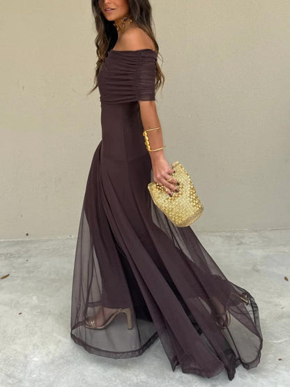 Side view of the dark brown off-shoulder dress with a sheer overlay skirt trailing behind 13