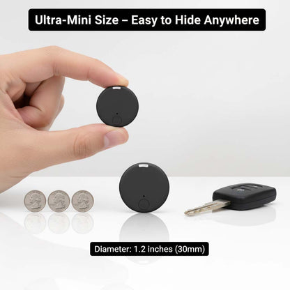 Hand pinching a small black round tracker, with another tracker on a white surface beside three coins and a car key for scale. 7