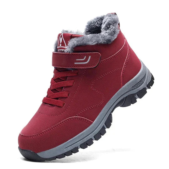 Red high-top boot with fluffy grey lining, strap, laces and grey tread sole, side view 5