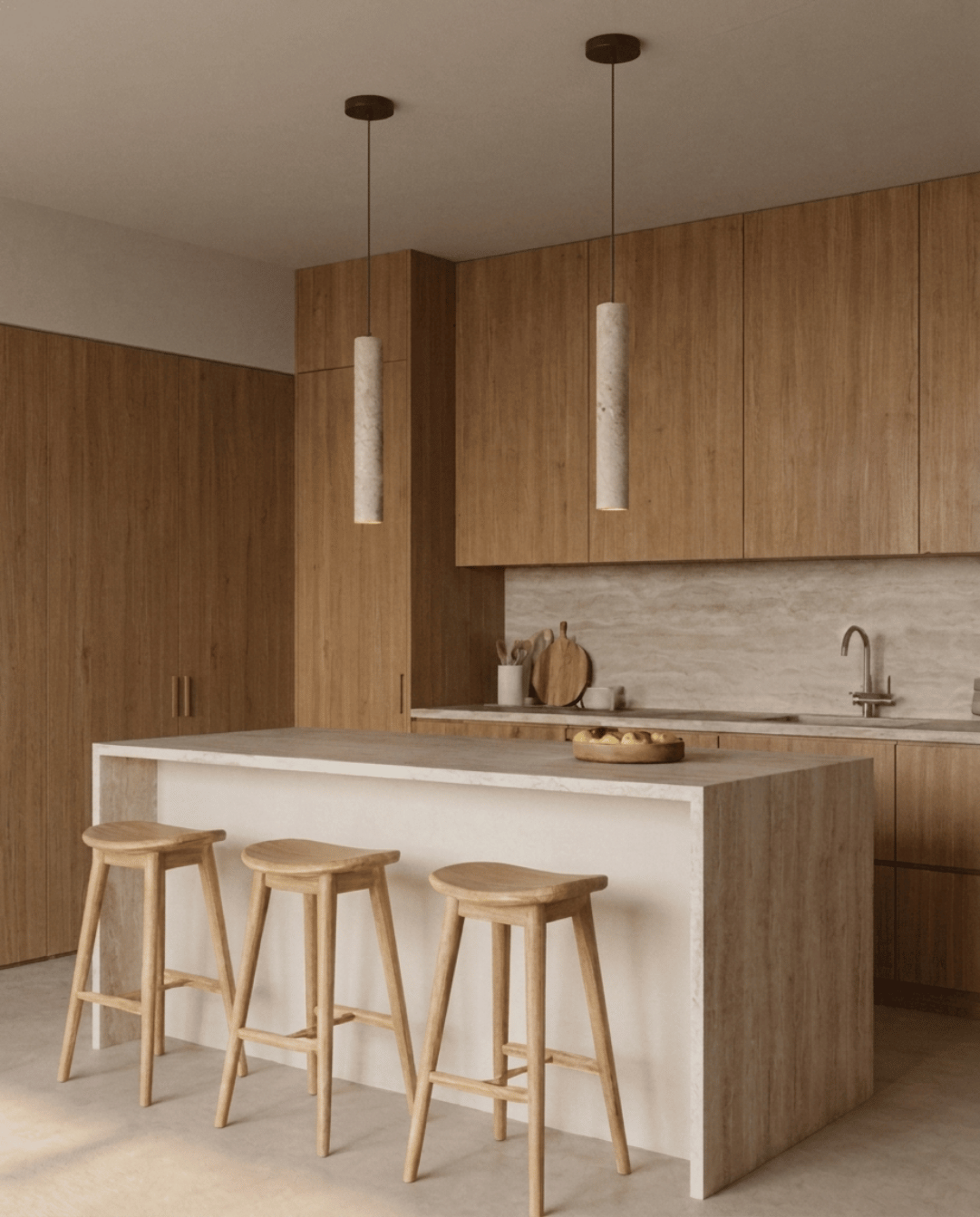 Two stone cylinder pendants hanging above a kitchen island with three wooden stools 3