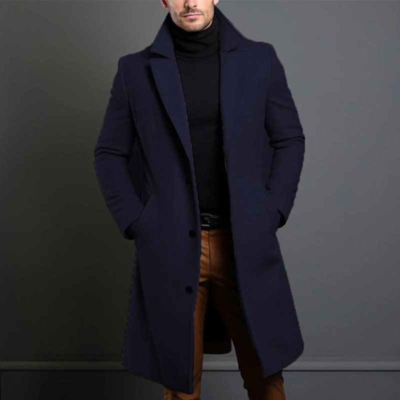 Model wearing the navy version of the longline coat with wide notch lapels, hands in pockets, over a black roll-neck. 4