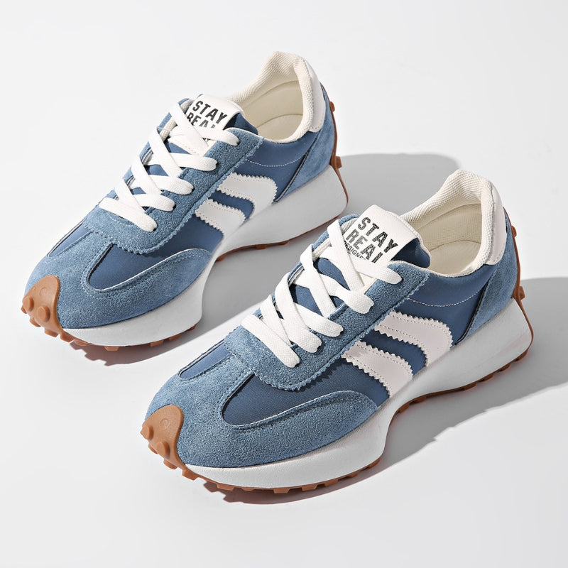 Pair of blue suede and nylon trainers with white side stripes and gum soles, seen from above 2