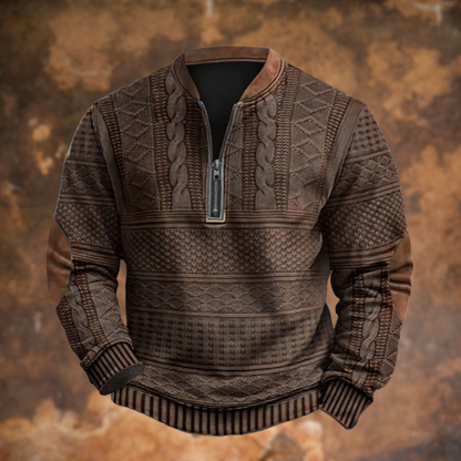 Front view of the dark brown version with cable and diamond knit panels, a silver-toned half zip and tan elbow patches, on a rusty backdrop. 4