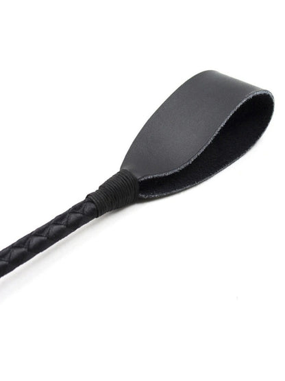 Close-up of the flat black leather tip, wrapped with black cord where it joins the quilted shaft. 2