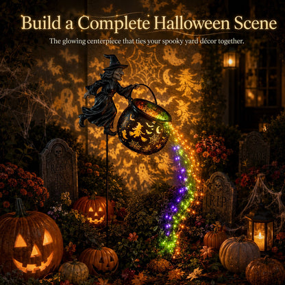 Witch cauldron light as the centrepiece of a spooky yard with carved pumpkins, gravestones, cobwebs and a candle lantern. 9