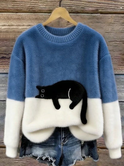 Fluffy jumper with mid blue upper half, white lower half and black cat patch, on a hanger 8