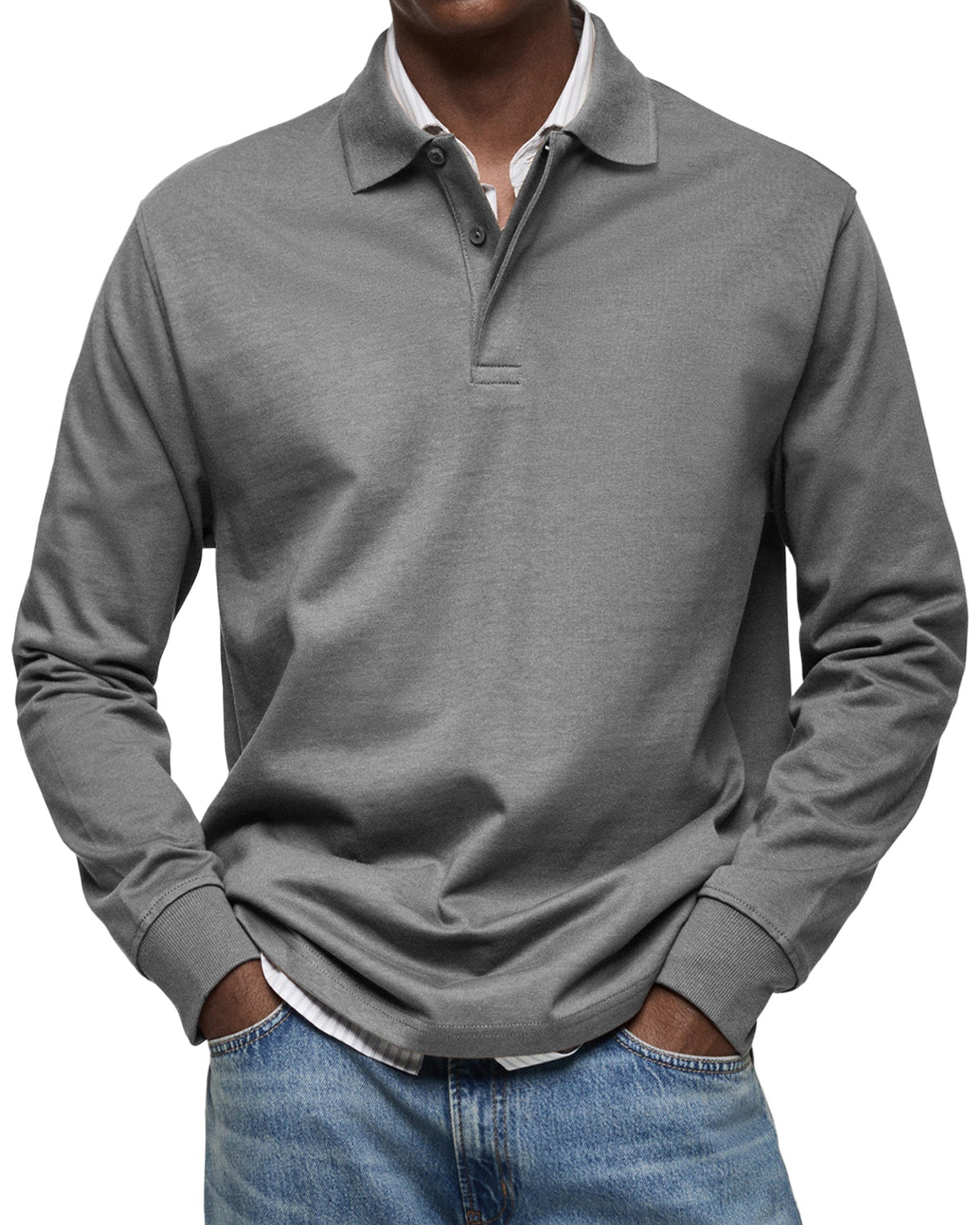 Model wearing the polo in mid grey, soft jersey fabric with ribbed cuffs, paired with light blue jeans. 6