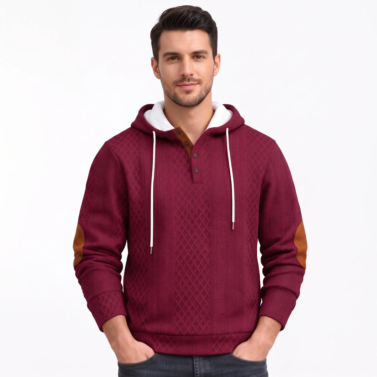 Model in burgundy textured hoodie with tan elbow patches, hands in pockets, plain background 40