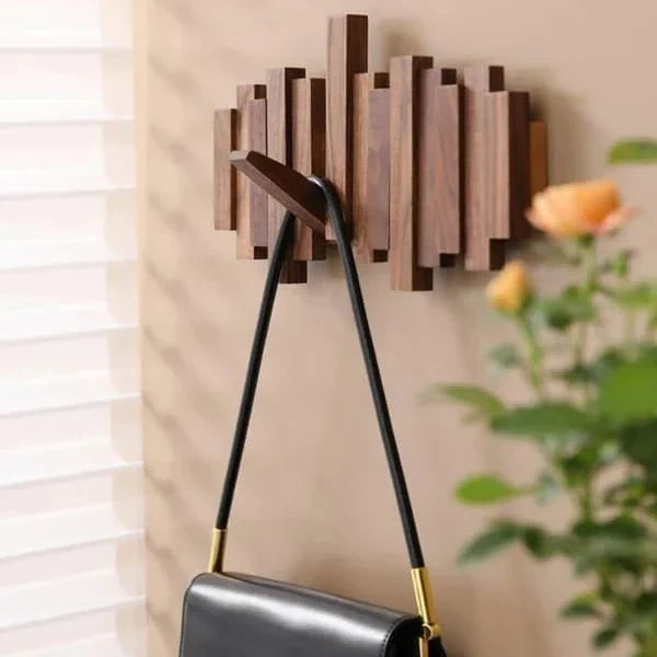 Small dark wooden rack with a black handbag on one hook, beside a window blind and roses 6