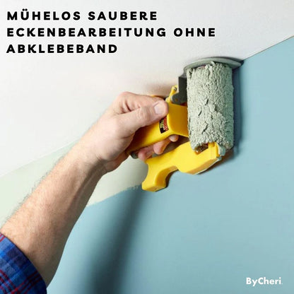 Man's hand using the yellow guide to roll pale green paint along the join between a white ceiling and blue wall. 2