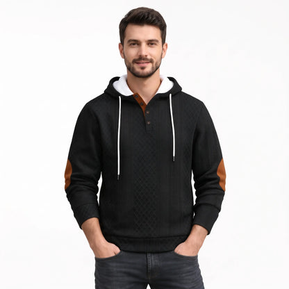 Model wearing the black textured diamond-pattern hoodie with white drawstrings, buttoned placket and tan elbow patches, hands 41