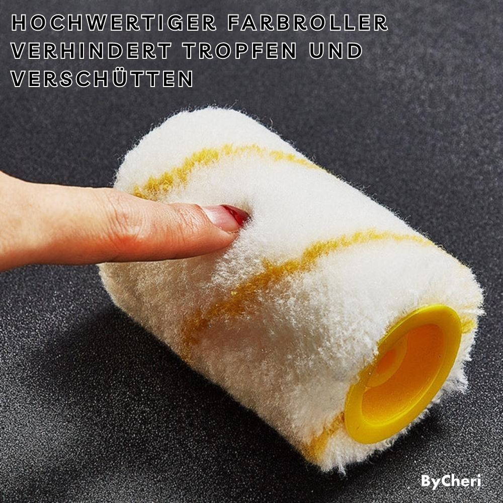 Spare white replacement roller with yellow stripes and a yellow core, pressed gently by a fingertip to show its soft pile. 7