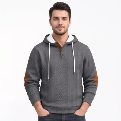 Model wearing the grey version of the textured hoodie, showing white hood lining, drawstrings and tan elbow patches 43