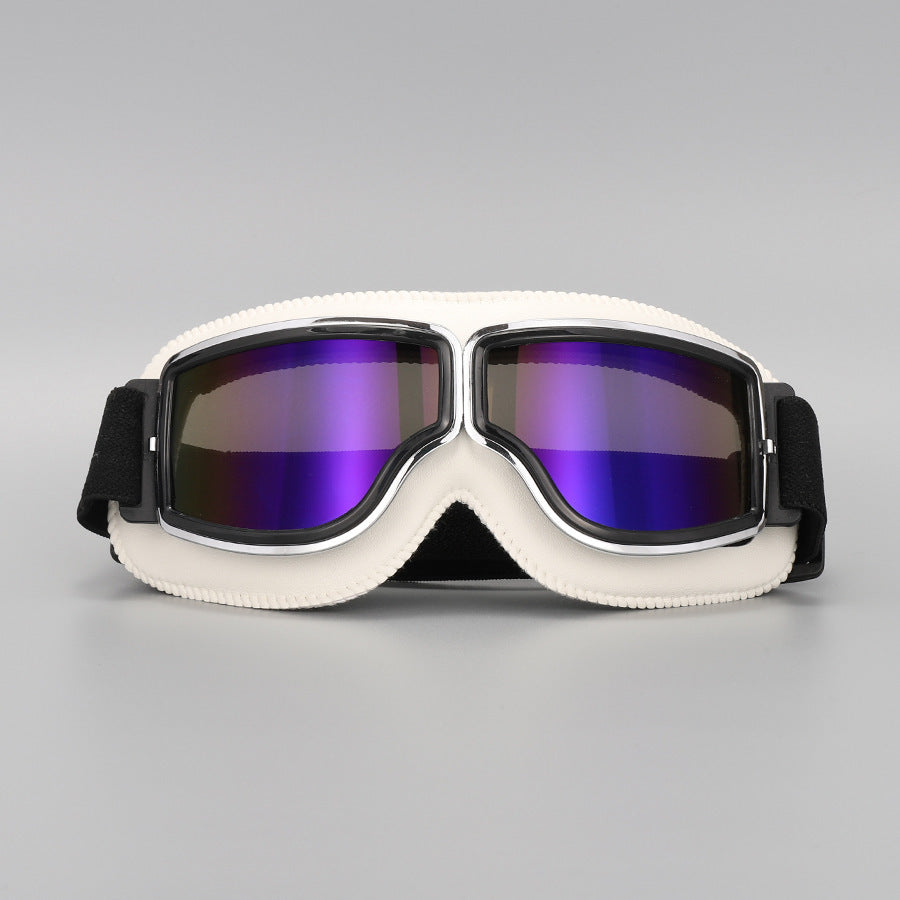 Front view of the cream-white padded goggles with chrome trim and purple mirrored lenses. 15