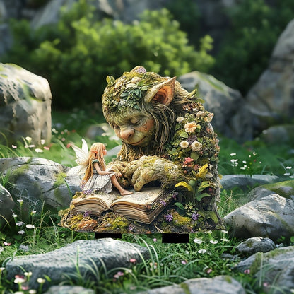 Troll with a small fairy sitting on its book, placed among rocks, grass and tiny white flowers. 12