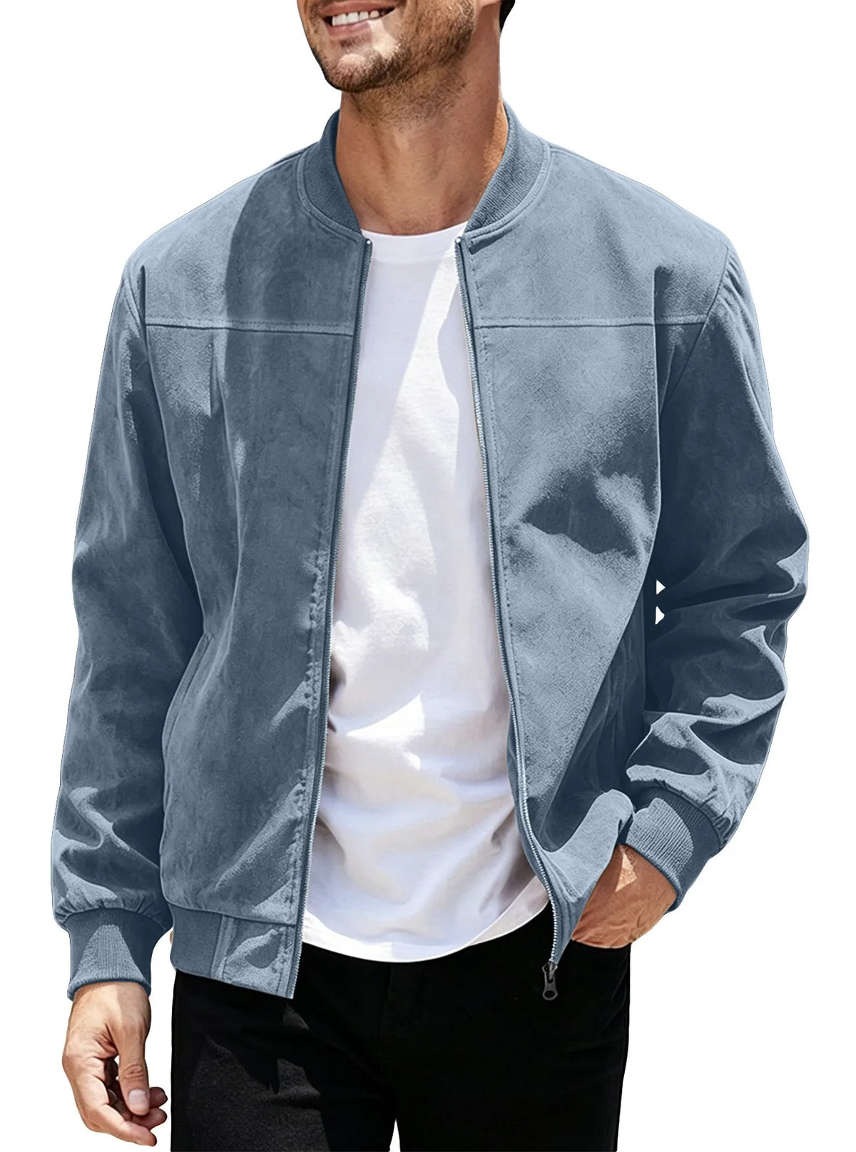 Smiling model wearing the dusty blue jacket unzipped over a white tee, one hand in pocket 47