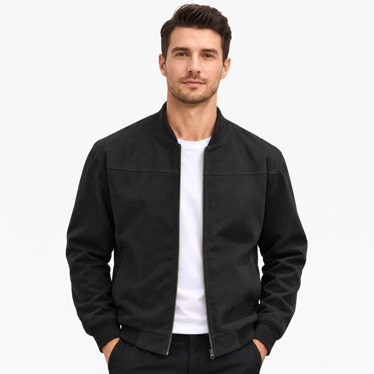 Studio shot of a model in the black jacket, zip open, hands in trouser pockets 49