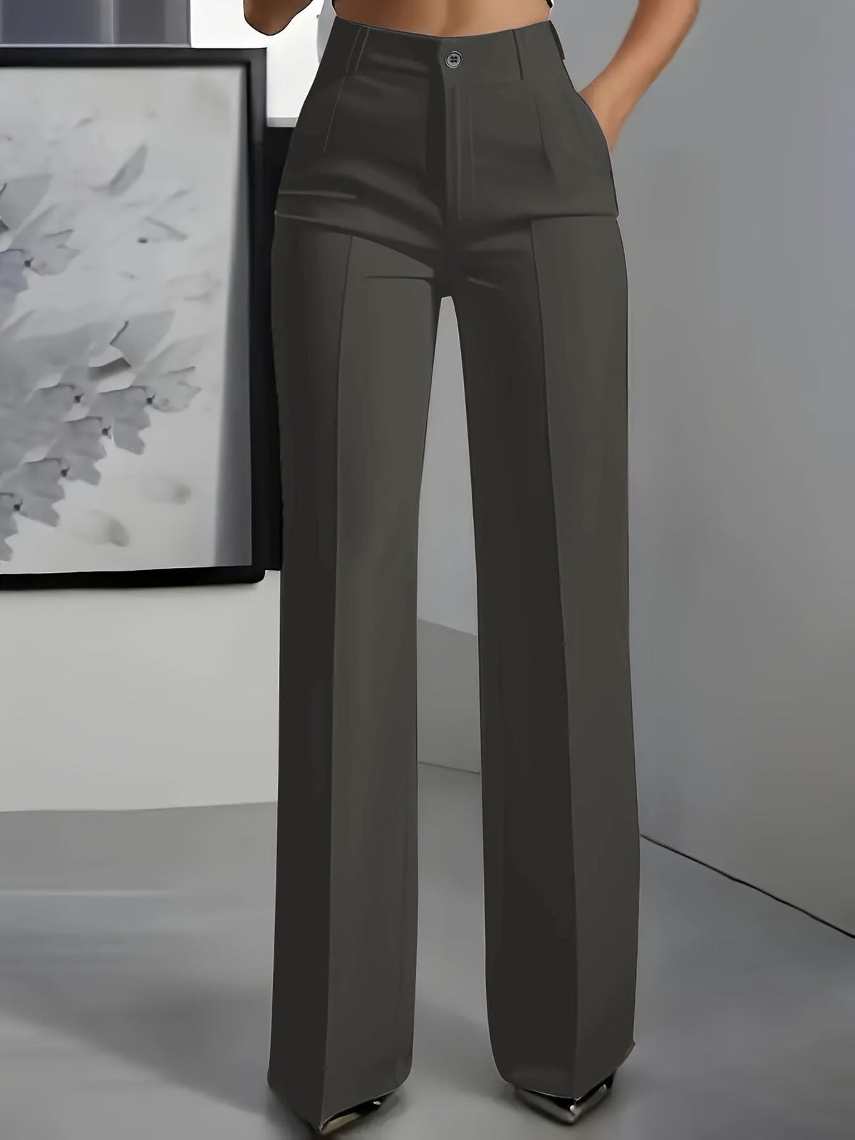 Front view of wide-leg trousers in dark grey with a centre crease, worn with a hand in the pocket 3