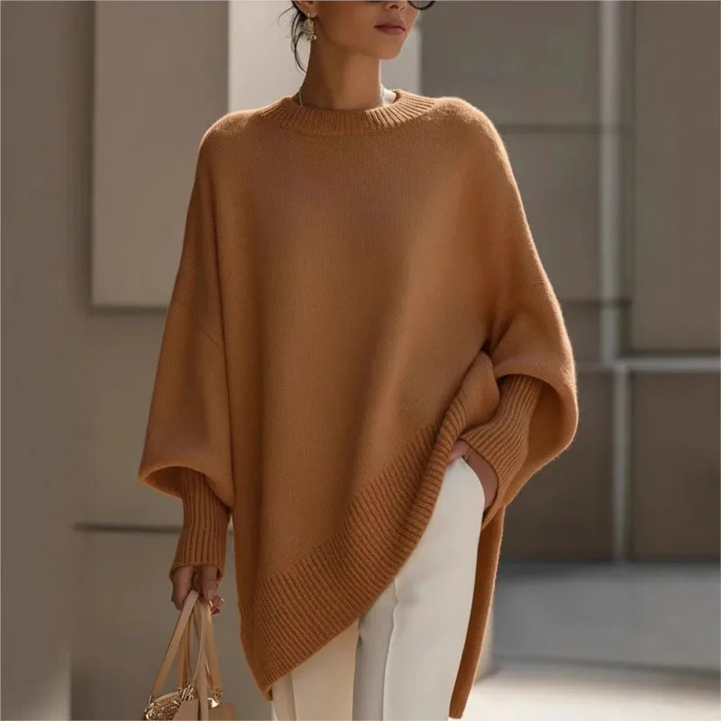 Camel-brown jumper with a ribbed round neck and hem, worn with white trousers and a handbag 4
