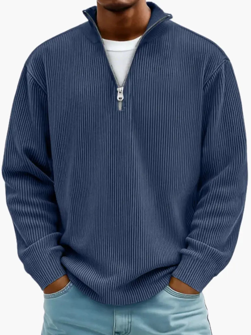 Man wearing the ribbed quarter-zip jumper in navy blue over a white tee, paired with light blue jeans. 5