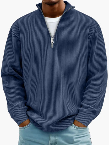 Man wearing the ribbed quarter-zip jumper in navy blue over a white tee, paired with light blue jeans. 5