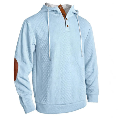 Pale blue textured hoodie on a plain white background, angled front view with button placket and tan elbow patch 4