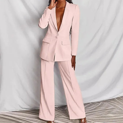 Pale pink suit, front view on a model with one hand raised, wide-leg trousers with centre crease 4