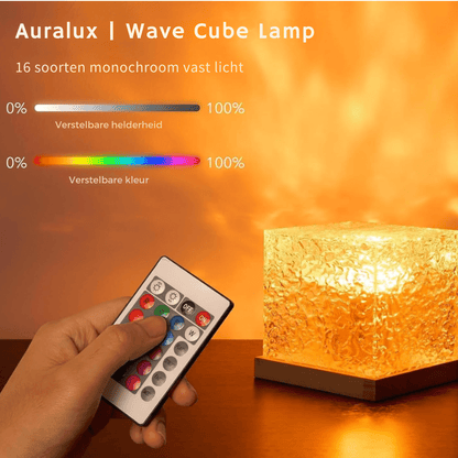 Hand pressing a button on the colour remote control beside a glowing amber cube lamp, with brightness and colour sliders above. 8