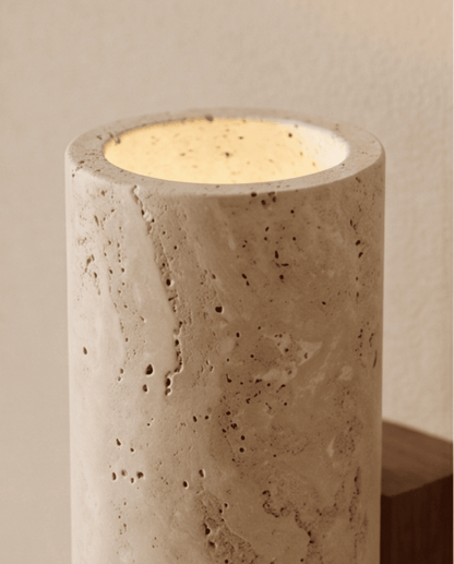 Close-up of the top opening, glowing warmly inside the pitted travertine cylinder 4