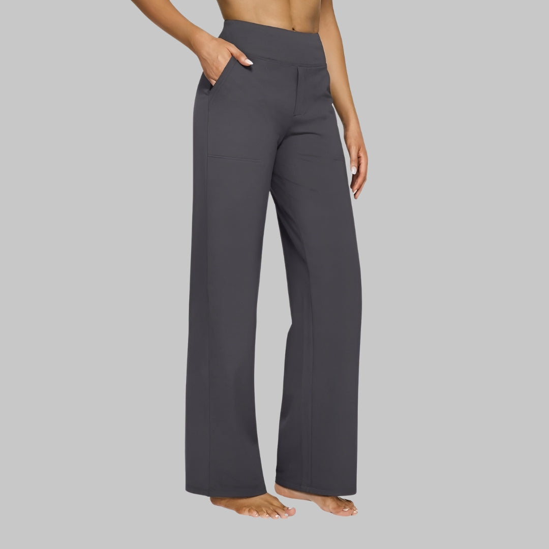 Dark grey version of the high-waist straight-leg trousers, worn by a model with a hand in the pocket. 6