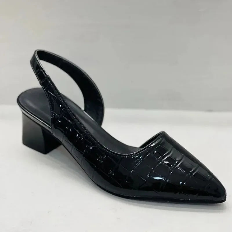 Single black patent croc-embossed slingback with pointed toe and block heel on a white surface 4
