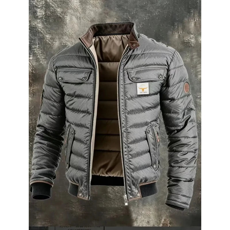 Grey version of the quilted jacket, unzipped to show the lining, on a textured grey backdrop 4