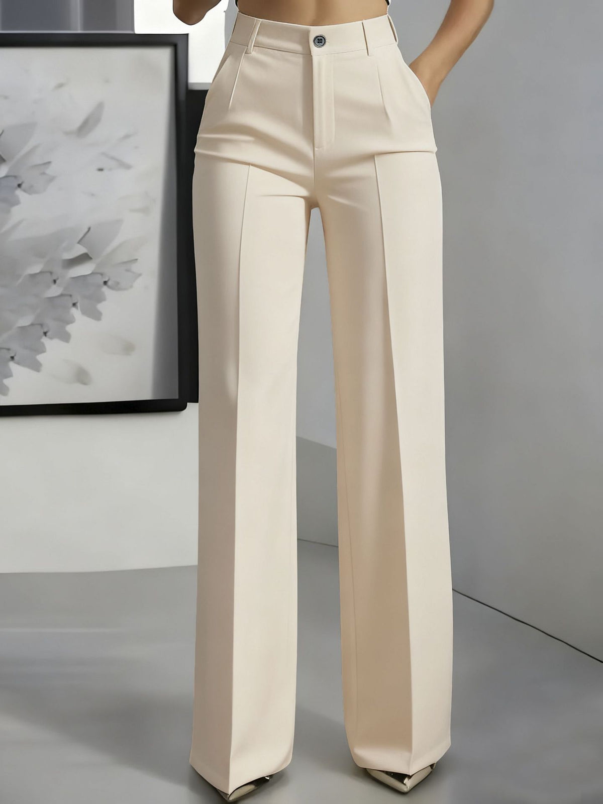 Front view of wide-leg trousers in cream with a centre crease, worn with a hand in the pocket 5