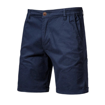 Front view of the shorts in navy blue, with a brown button, side pockets, elasticated waist and cuffed hems. 10
