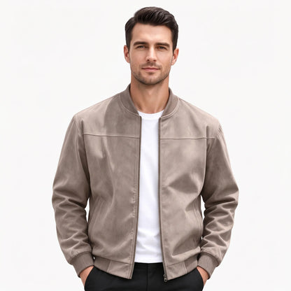 Studio shot of a model in the taupe jacket, zip open, hands in trouser pockets 50