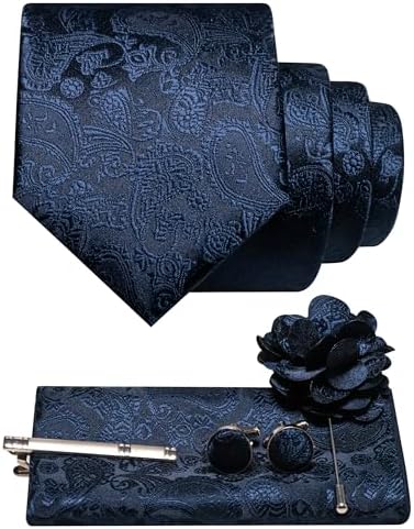 Navy blue paisley tie with matching pocket square, cufflinks, tie clip and flower lapel pin in a flat lay. 6
