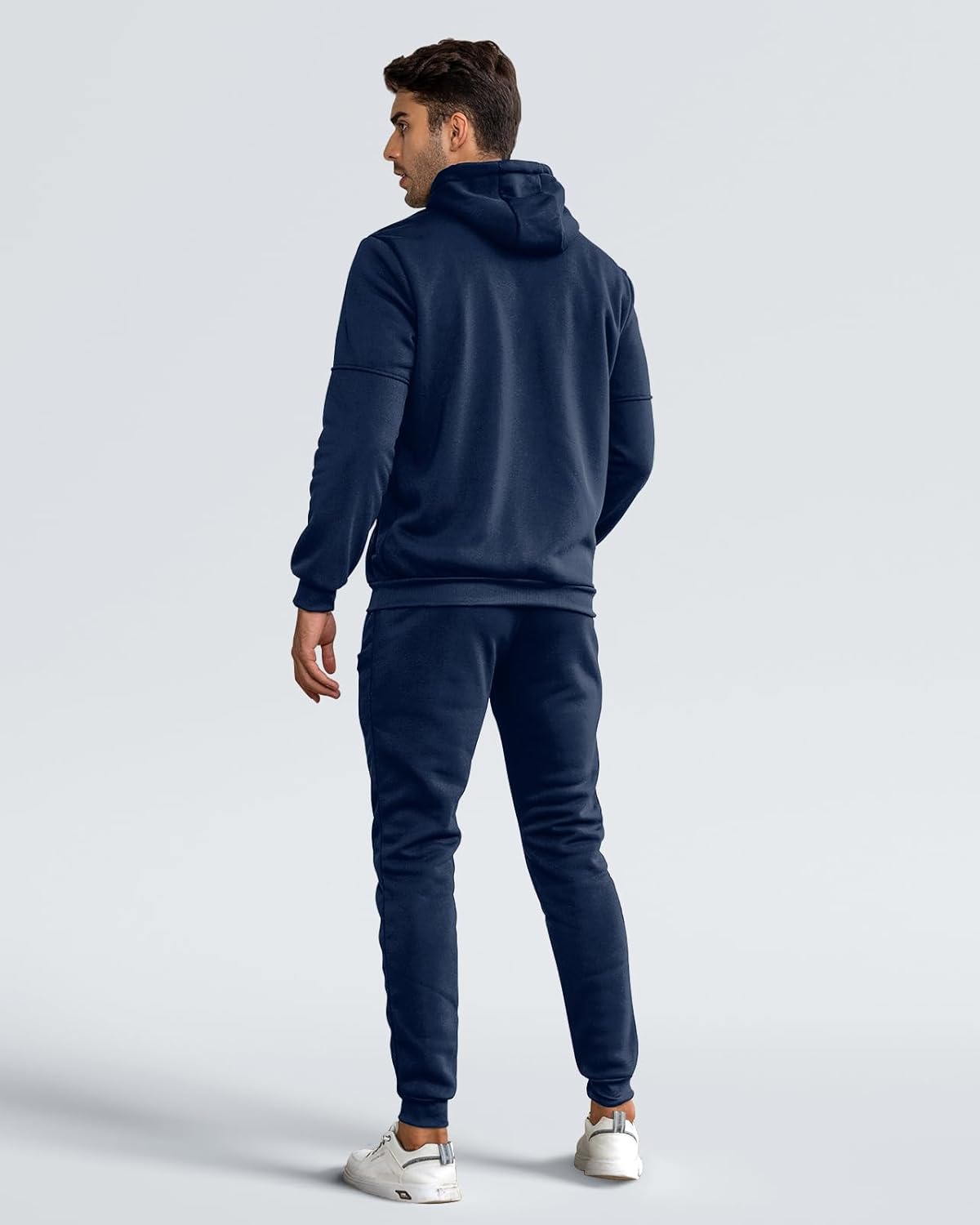 Back view of the navy hooded tracksuit on a model, showing the hood, ribbed hem and cuffs 3