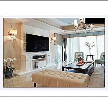 Wide-angle view of a bright living room with a wall-mounted television, bench, coffee table and chandelier 6