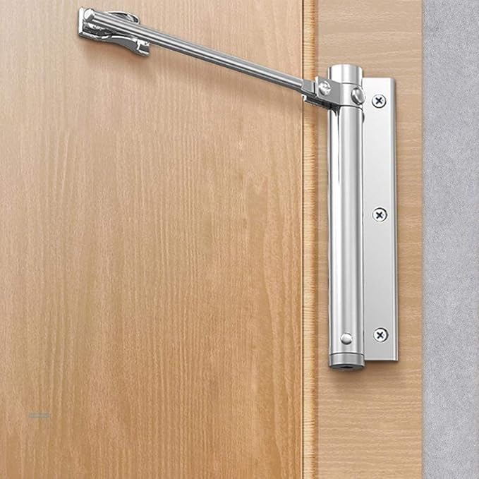 Polished silver closer mounted on a natural wood door and frame, arm angled upwards 2